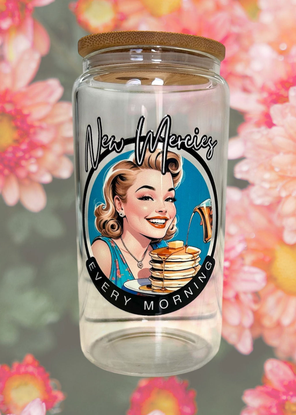 Glass jar with a decorative label featuring a vintage-style illustration of a woman with pancakes and the text 'New Mercies Every Morning' against a floral background.