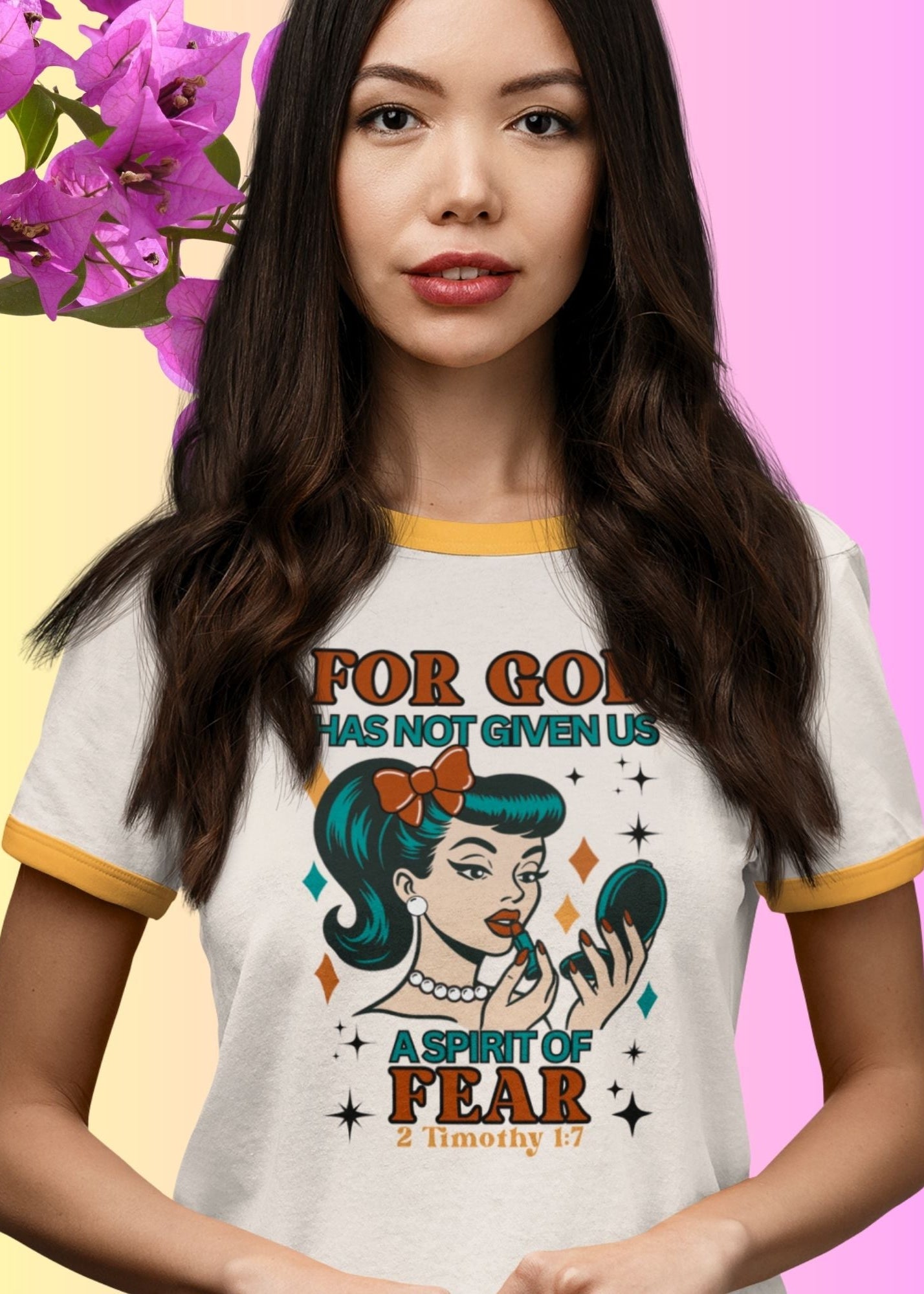 Woman wearing a t-shirt with a graphic design and text, standing against a colorful background.