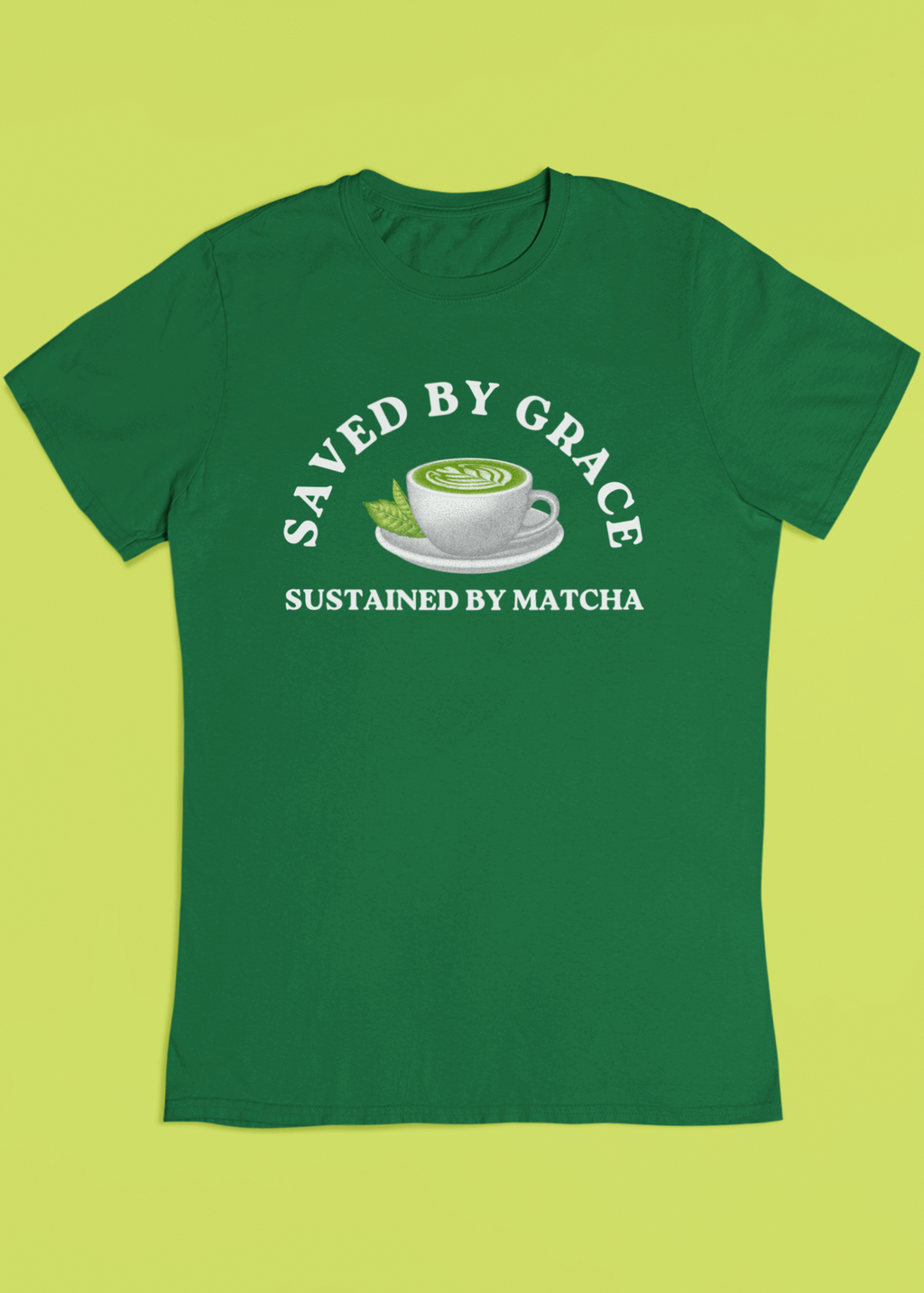 Green t-shirt with 'Saved by Grace, Sustained by Matcha' text and tea cup graphic on a green background