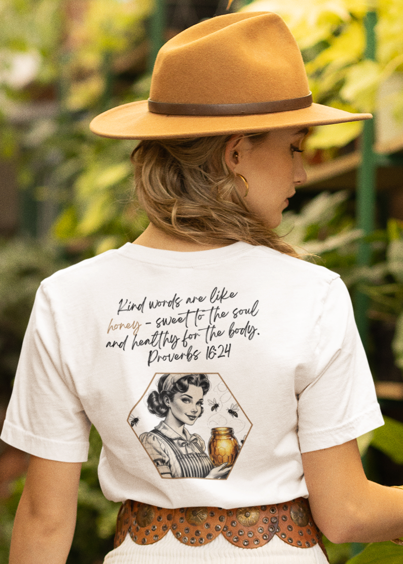Woman in a white dress and hat walking through a greenhouse filled with plants.