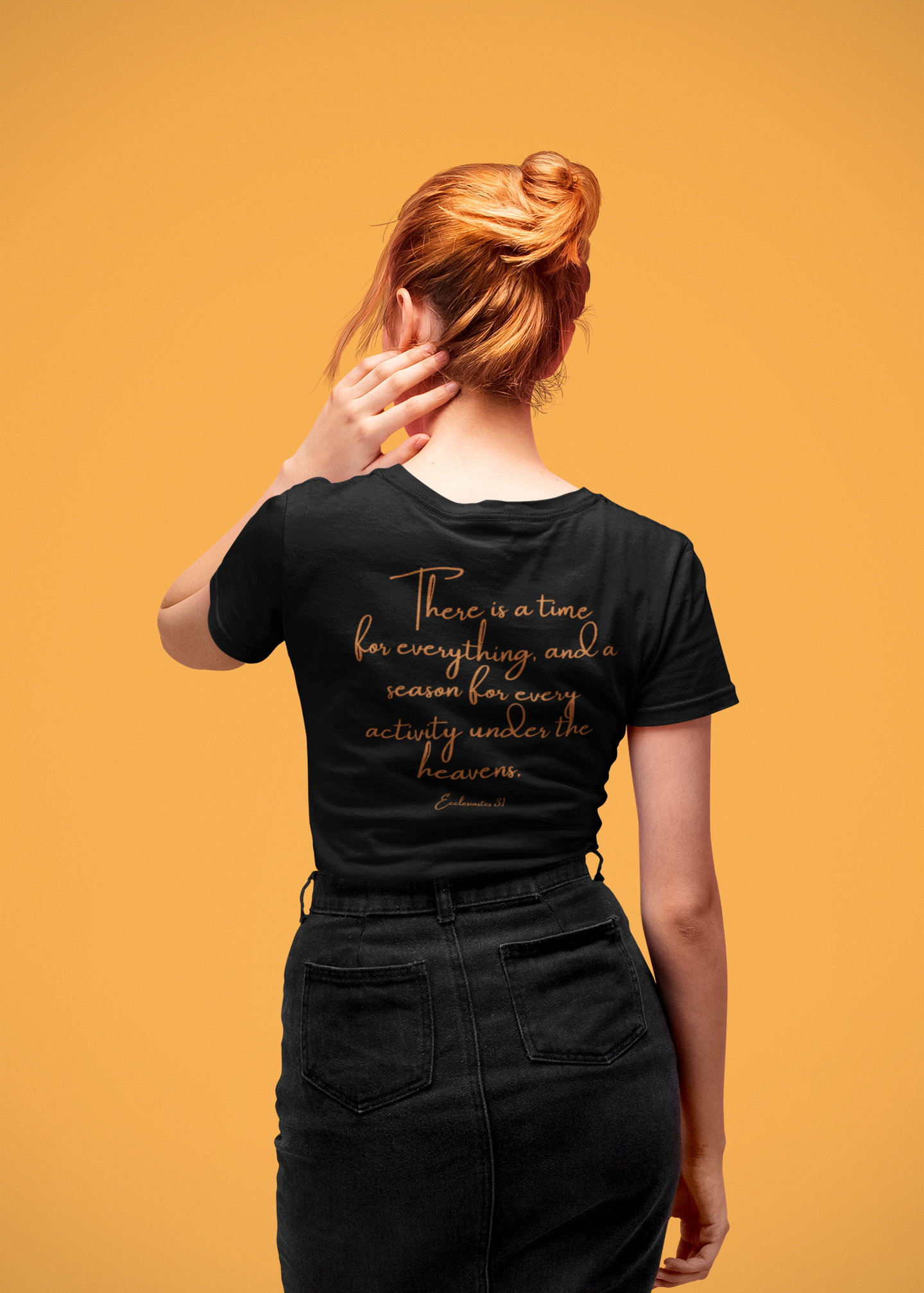 Person wearing a black t-shirt with orange text with a scripture on it