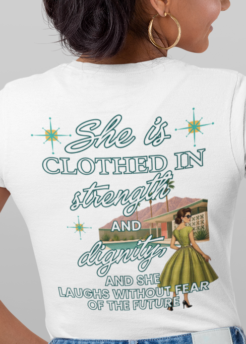 A woman modeling a white graphic t-shirt, shown from both the front and back against a solid gray background. The front features a small graphic of a retro spaceship, while the back displays a larger graphic with the text 'She is CLOTHED IN stars and space' and an illustration of a girl in a space suit.