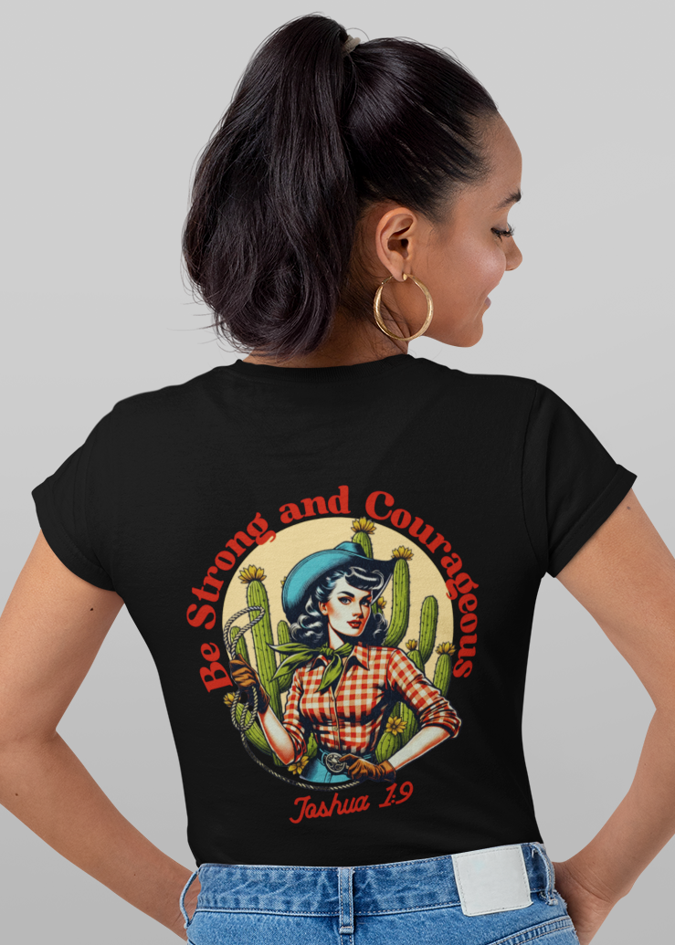 A woman modeling a black short-sleeve T-shirt shown from both front and back against a light gray studio background. The front has a small circular multicolor chest graphic, and the back has a large colorful graphic with red text reading 'Be Shit and Conquer' and 'Job Title: Boss.