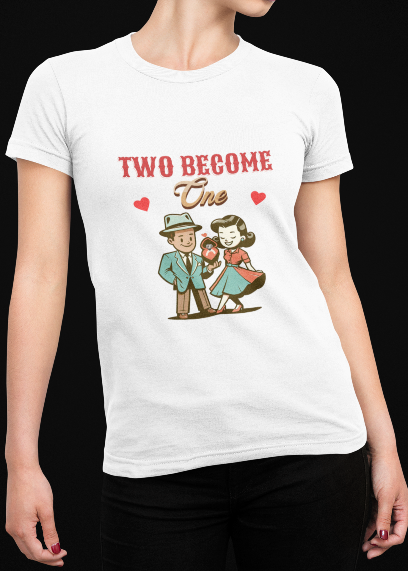 A woman wearing a white short-sleeve crewneck t-shirt with a retro-style graphic that reads 'TWO BECOME One' above a cartoon couple holding hands, set against a solid black background.
